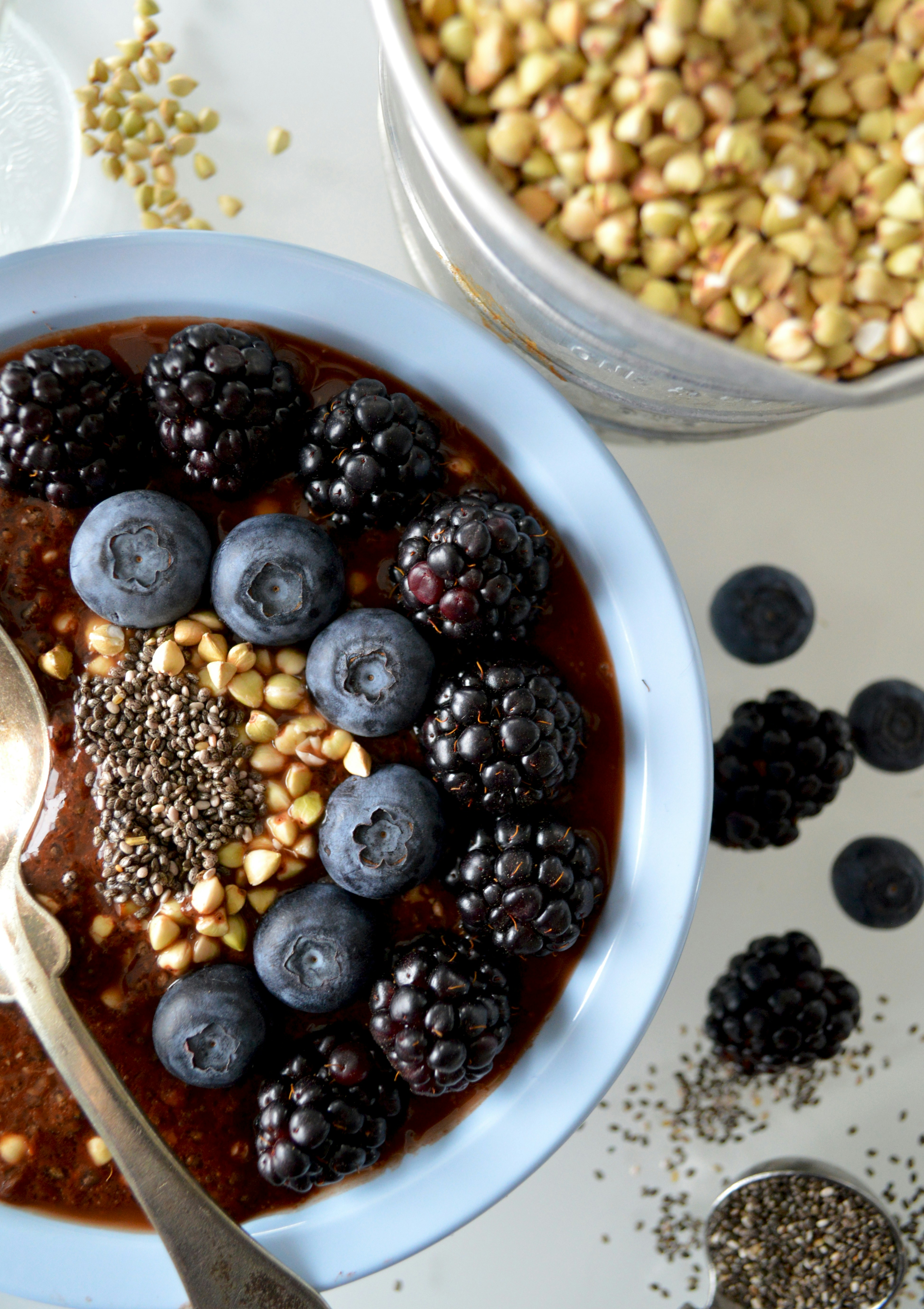 Chocolate breakfast bowl topped with blueberries, blackberries, and chia seeds